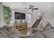 Open-concept living area with hardwood floors, ceiling fan, and staircase to the upper level at 7322 Columbia Rock Ct, Las Vegas, NV 89178