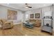 Open-concept living room with wood floors, a ceiling fan, and ample space at 7322 Columbia Rock Ct, Las Vegas, NV 89178