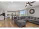 Spacious living room with hardwood floors, ceiling fan, and view of the kitchen at 7322 Columbia Rock Ct, Las Vegas, NV 89178