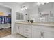 Bright bathroom featuring dual sinks, quartz countertops, and access to walk in closet at 7322 Columbia Rock Ct, Las Vegas, NV 89178