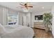 Primary bedroom featuring a ceiling fan, wood floors, and a decorative dresser at 7322 Columbia Rock Ct, Las Vegas, NV 89178