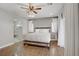 Serene primary bedroom with wood floors, ceiling fan, and a luxurious king-size bed at 7322 Columbia Rock Ct, Las Vegas, NV 89178