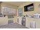 This outdoor kitchen is equipped with stainless steel appliances, mini fridge, and bar top for easy entertaining at 7322 Columbia Rock Ct, Las Vegas, NV 89178