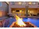 Inviting patio with outdoor kitchen, television, pool access, and comfortable seating area at 7322 Columbia Rock Ct, Las Vegas, NV 89178