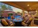Inviting covered patio featuring a fire pit, built in grill, pool and lounge seating at 7322 Columbia Rock Ct, Las Vegas, NV 89178