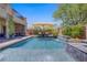 Inviting backyard pool with umbrella, lounge chairs, and lush greenery for a relaxing outdoor experience at 7322 Columbia Rock Ct, Las Vegas, NV 89178