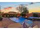 Relaxing backyard with pool, brick patio, fire bowls, water feature, and comfortable seating at 7322 Columbia Rock Ct, Las Vegas, NV 89178