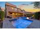 Beautiful backyard with a sparkling pool, spa, fire pit and covered patio for outdoor entertaining at 7322 Columbia Rock Ct, Las Vegas, NV 89178