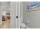 Tastefully decorated powder room with a toilet and view of the living room at 7322 Columbia Rock Ct, Las Vegas, NV 89178