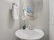 Clean powder room featuring a sink, mirror, and decorative accents at 7322 Columbia Rock Ct, Las Vegas, NV 89178