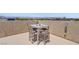 Stylish rooftop patio with table and seating offers scenic views and a perfect space for outdoor relaxation at 7322 Columbia Rock Ct, Las Vegas, NV 89178