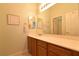 Bright bathroom featuring a sink with double mirrors and wood cabinets at 7325 Rustic Crest St, Las Vegas, NV 89149