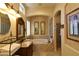 Elegant bathroom featuring a soaking tub, shower, and custom vanity with decorative mirrors and classic fixtures at 7325 Rustic Crest St, Las Vegas, NV 89149