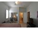 Well-lit bedroom with shutters, TV, closet, with door leading to a bathroom at 7325 Rustic Crest St, Las Vegas, NV 89149
