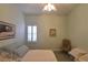 Bedroom with plantation shutters, comfortable bed, art pieces, and relaxing chair at 7325 Rustic Crest St, Las Vegas, NV 89149