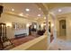 Dining room area with large chandelier, wood table and floors, and view of living space at 7325 Rustic Crest St, Las Vegas, NV 89149