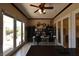 Spacious home office with ceiling fan, built-in shelving and large sliding doors to backyard patio at 7325 Rustic Crest St, Las Vegas, NV 89149