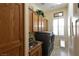 Functional laundry room with wooden cabinets, sink, and modern washer and dryer set at 7325 Rustic Crest St, Las Vegas, NV 89149