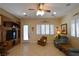 Cozy living room features a built-in entertainment center, windows, and tile flooring at 7325 Rustic Crest St, Las Vegas, NV 89149