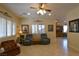 Airy living room with tiled floors, bright windows, and comfortable armchairs at 7325 Rustic Crest St, Las Vegas, NV 89149