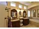 Main bathroom featuring double vanities, lots of counter space, and a soaking tub at 7325 Rustic Crest St, Las Vegas, NV 89149