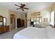 This main bedroom features a ceiling fan, ample closet space, and access to the en-suite bathroom at 7325 Rustic Crest St, Las Vegas, NV 89149