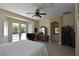 This main bedroom has a ceiling fan, tiled floors, and private backyard access at 7325 Rustic Crest St, Las Vegas, NV 89149