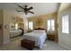 The main bedroom includes tiled flooring, an eye-catching accent wall, and plantation-shuttered windows at 7325 Rustic Crest St, Las Vegas, NV 89149