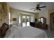 Bright bedroom with textured walls, ceiling fan, shuttered windows, and access to an outdoor pool at 7325 Rustic Crest St, Las Vegas, NV 89149