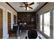 Inviting office space featuring custom built-ins, a ceiling fan, and French doors leading to a patio at 7325 Rustic Crest St, Las Vegas, NV 89149