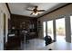 Office area featuring custom built-ins, a ceiling fan, and French doors leading to a patio at 7325 Rustic Crest St, Las Vegas, NV 89149