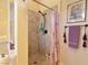 Tiled shower featuring neutral colored tile, contrasting fixtures, and decorative wall art at 7325 Rustic Crest St, Las Vegas, NV 89149