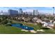 Breathtaking aerial view of the community, with city skyline in the backdrop, lush landscaping, and a pond at 778 Vegas Valley Dr, Las Vegas, NV 89109