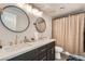 Modern bathroom featuring dual sinks, round mirrors, and black fixtures at 778 Vegas Valley Dr, Las Vegas, NV 89109