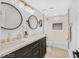 Modern bathroom featuring dual sinks, dark cabinetry, and decorative tile at 778 Vegas Valley Dr, Las Vegas, NV 89109