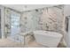 This modern bathroom features a standalone tub and walk-in shower with elegant marble tiling at 778 Vegas Valley Dr, Las Vegas, NV 89109