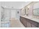 This bathroom features double sinks, a marble accent wall, and a glass-enclosed shower and tub at 778 Vegas Valley Dr, Las Vegas, NV 89109