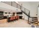 Modern kitchen with black cabinetry, white quartz countertops, an island with seating, and a staircase at 778 Vegas Valley Dr, Las Vegas, NV 89109