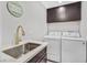 Laundry room with modern fixtures and a front-load washer and dryer at 778 Vegas Valley Dr, Las Vegas, NV 89109