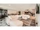 Spacious living room with a large sectional sofa, stylish rug, and adjacent dining area with stairs in view at 778 Vegas Valley Dr, Las Vegas, NV 89109