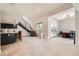 Bright living room with a modern staircase, adjacent office space, and tile flooring at 778 Vegas Valley Dr, Las Vegas, NV 89109
