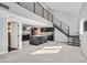 Spacious living room with a kitchen, stairs, and modern design elements at 778 Vegas Valley Dr, Las Vegas, NV 89109