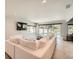 Bright and open living area with a large white sectional sofa and a view of the pool at 778 Vegas Valley Dr, Las Vegas, NV 89109