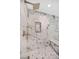 A frameless walk-in shower with marble-style tiling and a built-in bench showcases luxury at 778 Vegas Valley Dr, Las Vegas, NV 89109