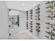 Wine room with glass door showcases wine racks against a wall, holding various wine bottles at 778 Vegas Valley Dr, Las Vegas, NV 89109