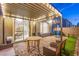Charming back patio offers an outdoor dining area, covered seating, and a basketball court at 8021 Adelaide Hills St, Las Vegas, NV 89113