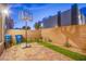 Backyard features an outdoor basketball hoop, artificial grass, and a brick fence at 8021 Adelaide Hills St, Las Vegas, NV 89113