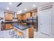 Modern kitchen featuring a central island with seating, stainless steel appliances, and warm wood cabinetry at 8021 Adelaide Hills St, Las Vegas, NV 89113