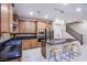 Modern kitchen with stainless steel appliances, dark countertops, and stylish island with bar stool seating at 8021 Adelaide Hills St, Las Vegas, NV 89113