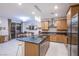 Open-concept kitchen with stainless steel appliances, dark countertops, and view into the dining area at 8021 Adelaide Hills St, Las Vegas, NV 89113